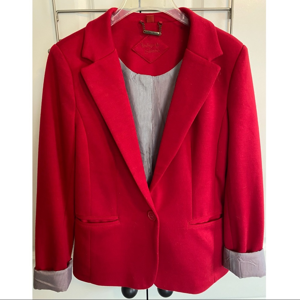 Red blazer with white and black stripe lining